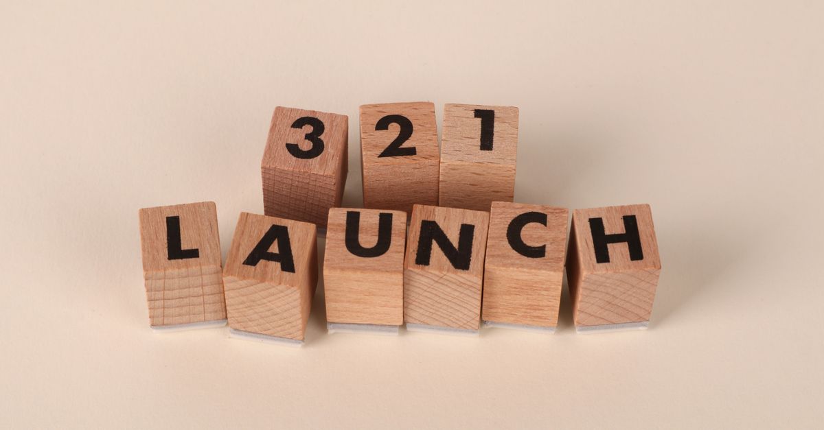Wooden blocks arranged to spell '3, 2, 1 Launch' symbolizing a countdown.