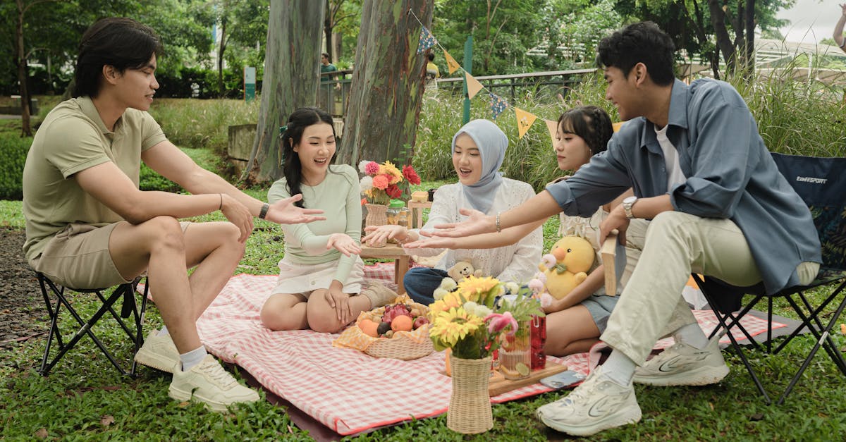 Cheerful family having a picnic in a lush Jakarta park with food and fun.