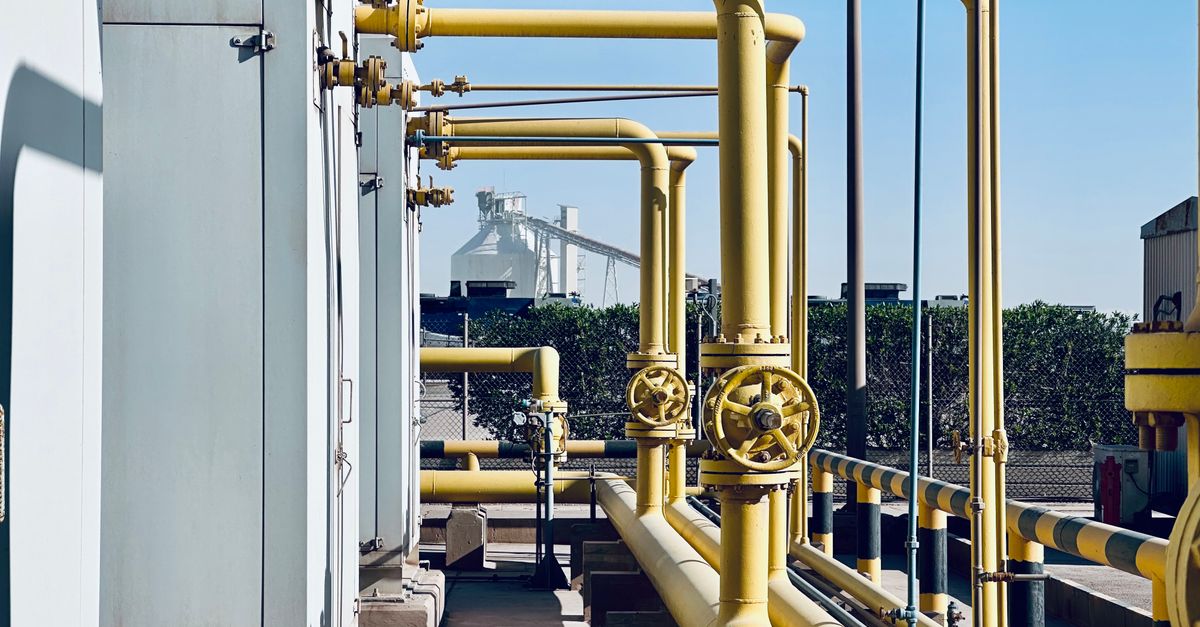 A detailed view of industrial pipelines in a Saudi Arabian factory setting.