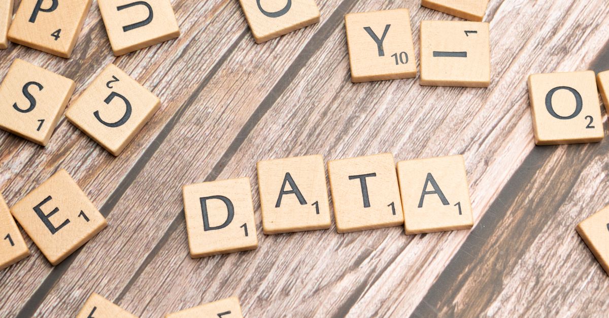 Wooden letter tiles spelling 'DATA' on a wood textured surface, symbolizing data concepts.