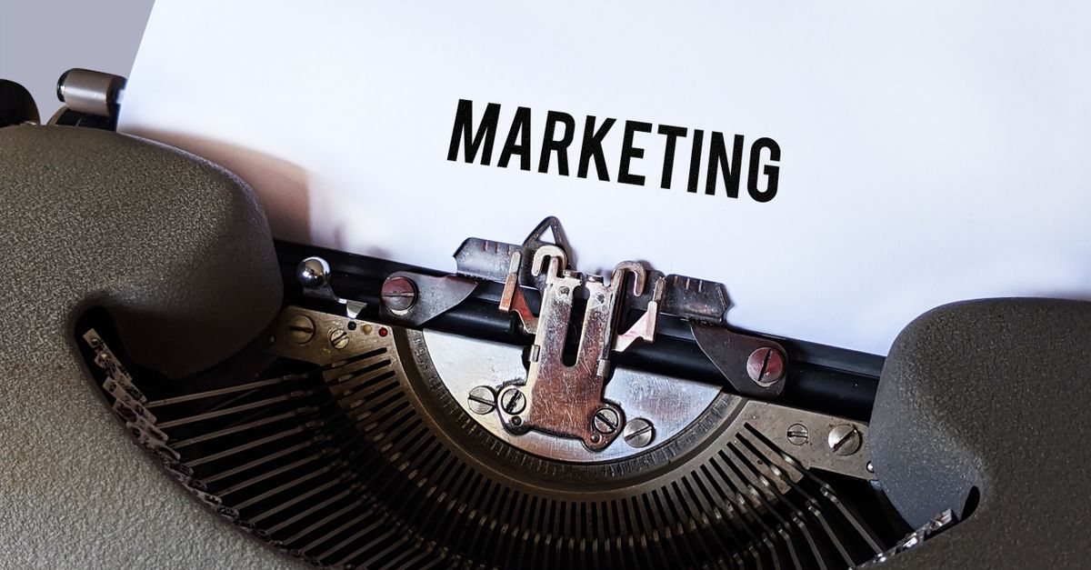 Close-up of a vintage typewriter with the word 'Marketing' on paper, conveying a retro business theme.