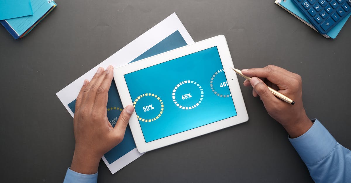 A professional reviewing statistical data on a digital tablet. Top view of business analysis.