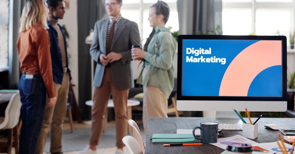 A diverse team collaborates in a modern office setting, discussing digital marketing strategies.