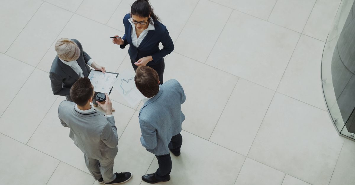 Group of business professionals collaborating in an office setting.