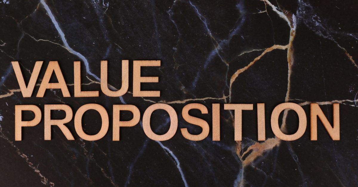 Wooden letters spelling 'Value Proposition' on a marble background, symbolizing business strategy.