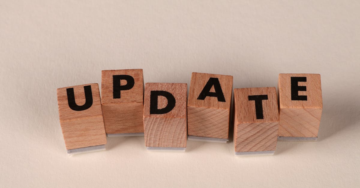 Wooden letter blocks arranged to spell 'Update' on a beige surface.