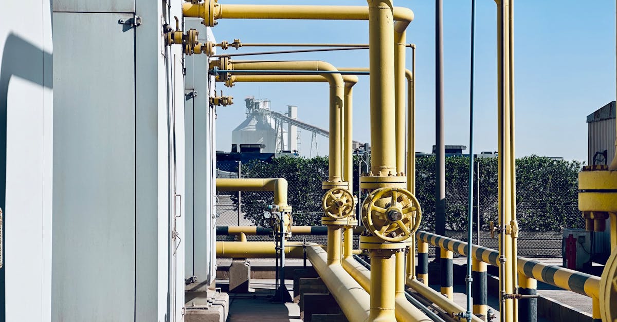 A detailed view of industrial pipelines in a Saudi Arabian factory setting.