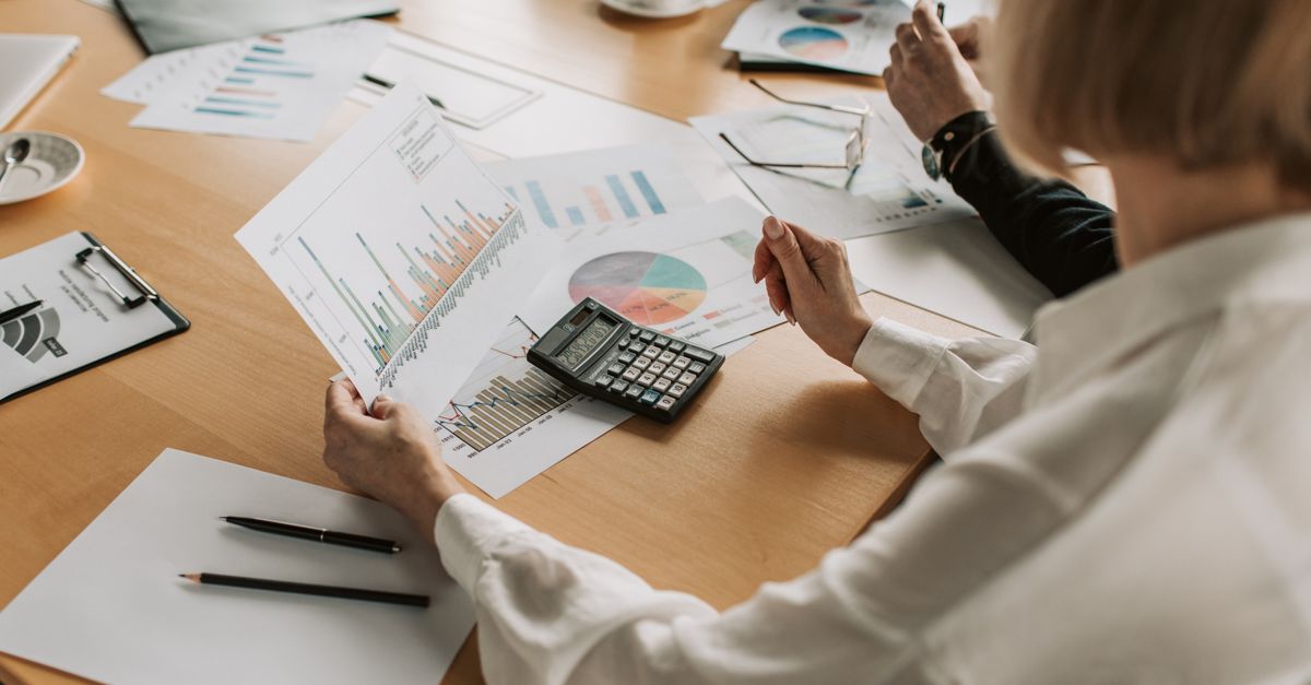 Business team analyzing financial data and graphs during a meeting to strategize growth.