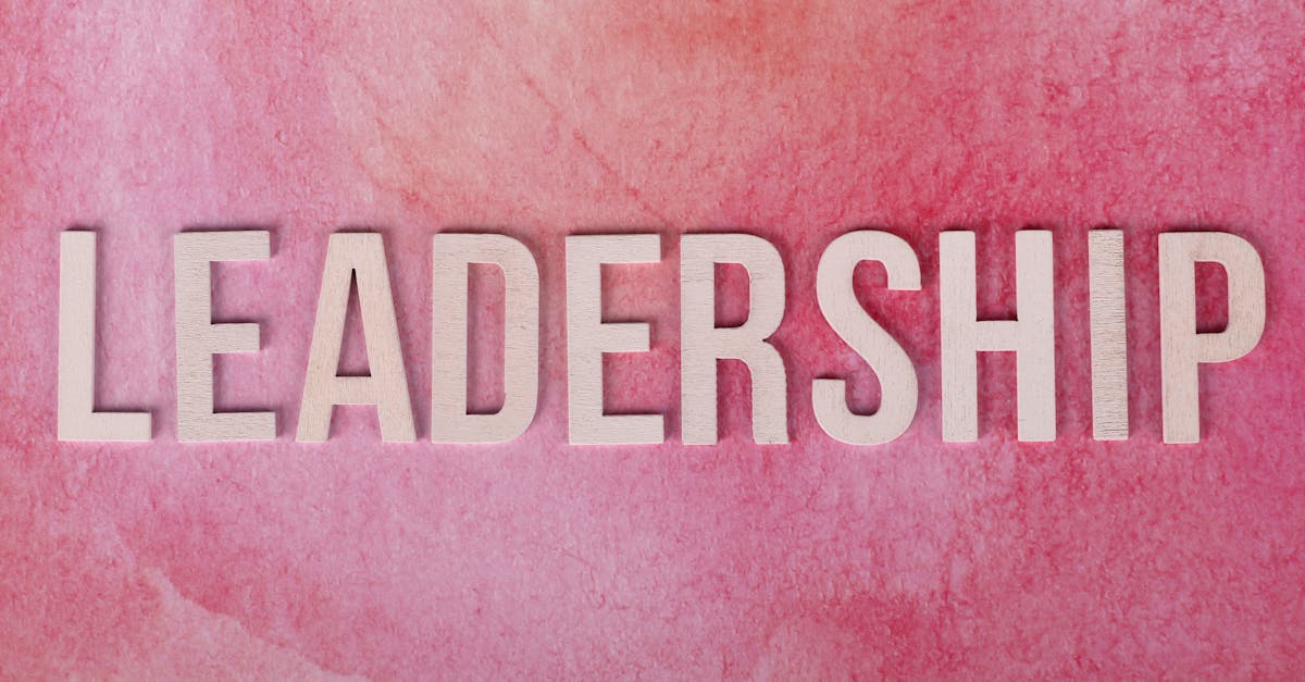 Inspirational leadership text on a vibrant pink watercolor background.