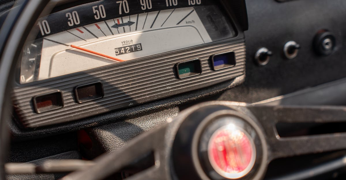 Close-up of a vintage car speedometer, showcasing classic dashboard design.