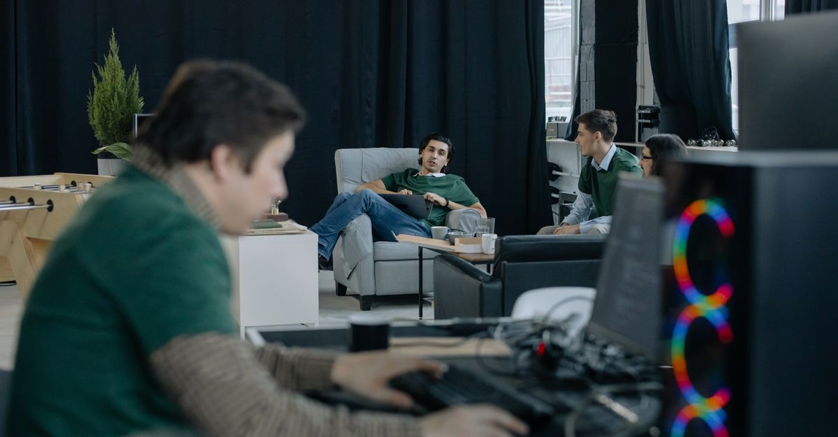 Focused group of professionals in a modern office discussing ideas and working collaboratively.