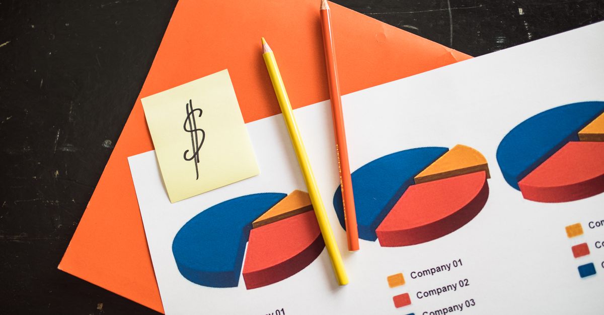A creative arrangement of financial pie charts with colorful pencils and a dollar note, perfect for business themes.