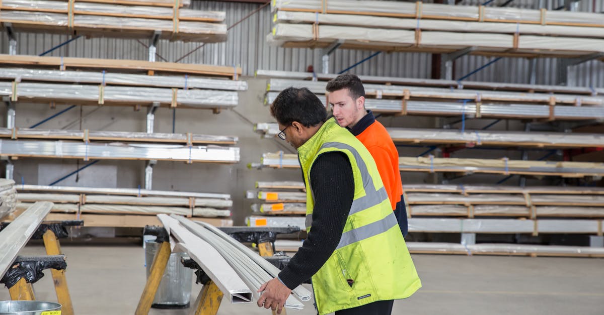 Two workers inspecting materials in a warehouse, focusing on quality control and inventory management.