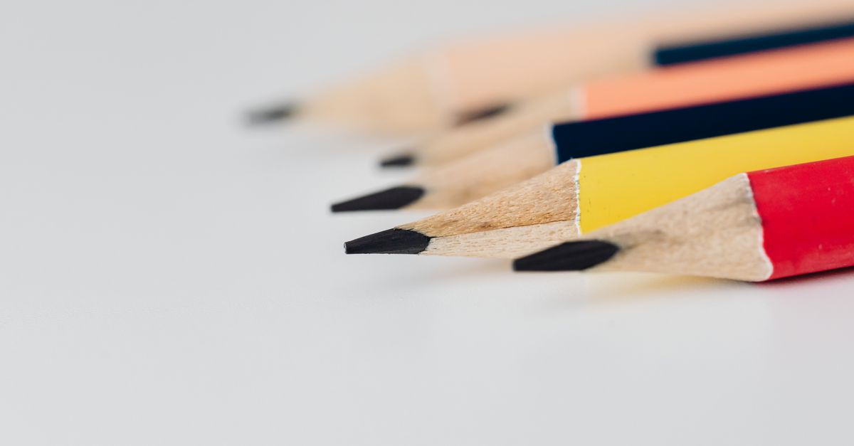 Vivid close-up of sharpened colored pencils on a white background, emphasizing creativity.