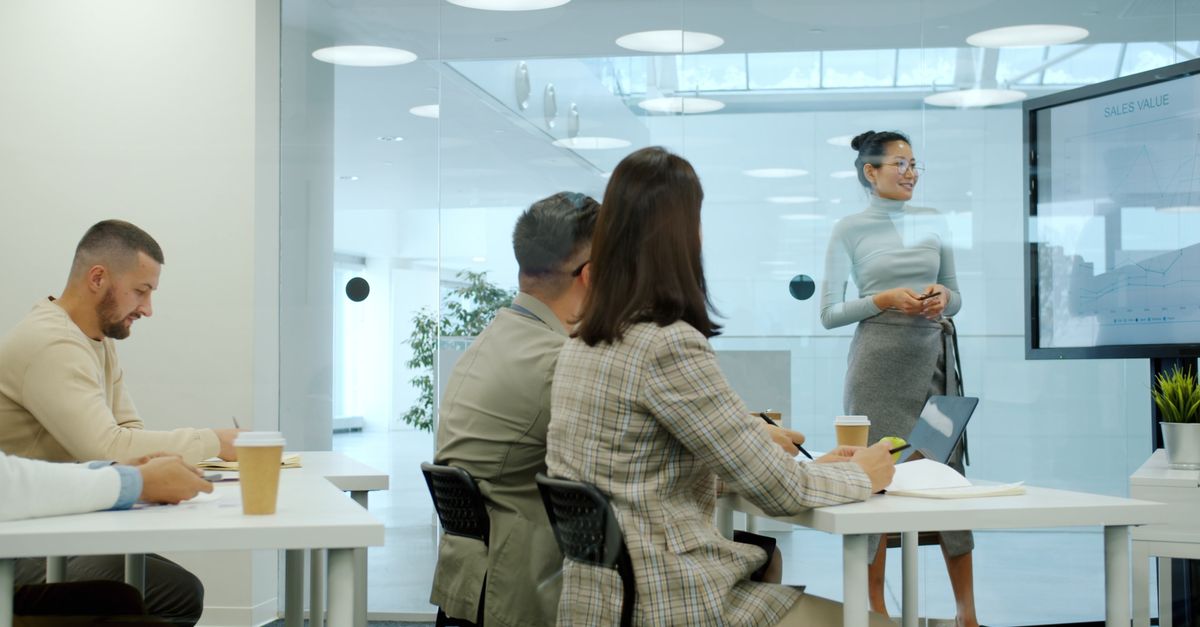 Professionals engaged in a business presentation indoors with modern decor.
