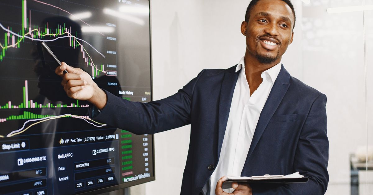 Businessman presents financial data using graphs, showcasing technology and analysis in a corporate environment.